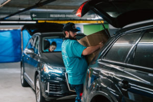 Volunteers carry donations of gifts, clothing, and more during the annual Adopt-a-Family LA  distribution event on Dec. 13 at the Cathedral of Our Lady of the Angels. (Peter Lobato)