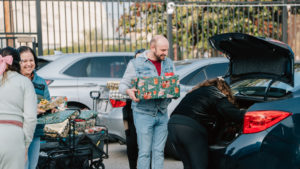 Volunteers carry donations of gifts, clothing, and more during the annual Adopt-a-Family LA  distribution event on Dec. 13 at the Cathedral of Our Lady of the Angels. (Peter Lobato)