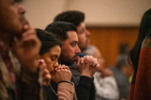 Parishioners pray at Sacred Heart Church in Altadena during a Jan. 7 healing Mass on the one-year anniversary of the Eaton Fire. (John Rueda)