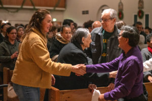 Parishioners greet each other at Sacred Heart Church in Altadena during a Jan. 7 healing Mass. (John Rueda)