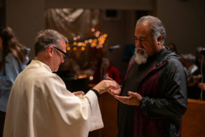 Father Gilbert Guzman, pastor of Sacred Heart Church in Altadena, offers Anointing of the Sick during a Jan. 7 healing Mass on the one-year anniversary of the Eaton Fire. (John Rueda)