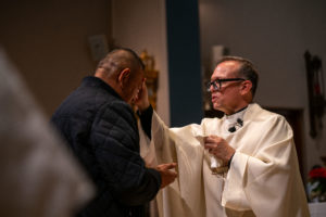 Father Gilbert Guzman, pastor of Sacred Heart Church in Altadena, offers Anointing of the Sick during a Jan. 7 healing Mass on the one-year anniversary of the Eaton Fire. (John Rueda)