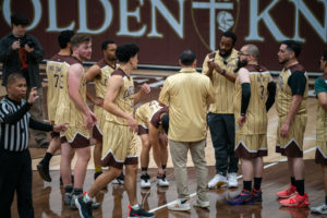 The Capuchin Franciscans huddle up during a timeout while playing against the seminarians in the Archdiocese of Los Angeles' annual priests vs. seminarians basketball game, this year on Jan. 18 at St. Francis High School in La Cañada Flintridge. (John Rueda)