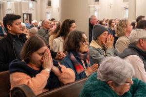 Parishioners pray at St. Monica Church in Santa Monica during a Jan. 7 Mass on the one-year anniversary of the Palisades Fire that burned down Corpus Christi Church. (Elizabeth Friedrich)