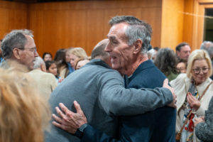 Parishioners greet each other at St. Monica Church in Santa Monica during a Jan. 7 Mass on the one-year anniversary of the Palisades Fire that burned down Corpus Christi Church. (Elizabeth Friedrich)