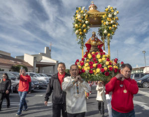 The Santo Niño statue is carried during the Sinulog celebration after a Mass held at St. Philomena Church in Carson on Jan. 17. (Juanito Holandez Jr.)