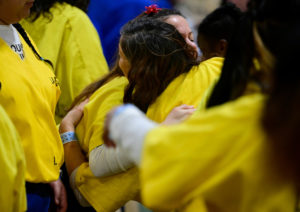 Inmates hug during the Sign of Peace in Mass at Century Regional Detention Facility in Lynwood, LA County’s largest women’s jail, on Christmas Day, Dec. 25, 2025. (John McCoy)