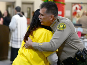 Los Angeles County Sheriff Robert Luna exchanged hugs and handshakes with female inmates during the Sign of Peace in Mass at Century Regional Detention Facility in Lynwood, LA County’s largest women’s jail, on Christmas Day, Dec. 25, 2025. (John McCoy)