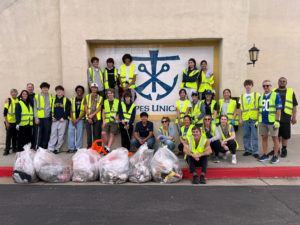 Students at Notre Dame High School participate in a day of service cleaning up trash on the streets near their school during Catholic Schools Week. (Notre Dame High School)