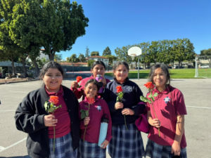 Students at Notre Dame School in Santa Barbara hold a flower to give to teachers and staff to thank them during Catholic Schools Week. (Notre Dame School)