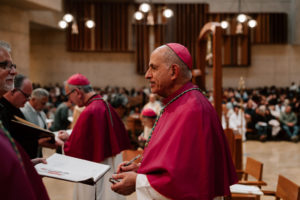 Auxiliary Bishop Albert Bahhuth signs a parish’s Book of the Elect during the Rite of Election ceremony at the Cathedral of Our Lady of the Angels on Feb. 15. (Peter Lobato)