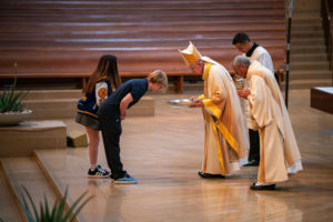 Archbishop José H. Gomez bows to students bringing up the gifts during the 2026 Christian Service Awards Mass on March 10 at the Cathedral of Our Lady of the Angels. (John Rueda)