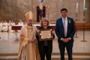 Archbishop José H. Gomez and Paul Escala, superintendent of LA Catholic schools, pose with Bosco Tech's Anne Sigoloff at the 2026 Christian Service Awards Mass on March 10 at the Cathedral of Our Lady of the Angels. (John Rueda)