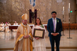Archbishop José H. Gomez and Paul Escala, superintendent of LA Catholic schools, pose with Immaculate Heart's Wilma Martin-Orozco at the 2026 Christian Service Awards Mass on March 10 at the Cathedral of Our Lady of the Angels. (John Rueda)