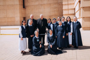Bishop Edward Clark  poses with women religious from the Lovers of the Holy Cross of Los Angeles after a March 26 Mass at the Cathedral of Our Lady of the Angels. (Isabel Cacho)