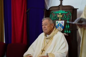 Bishop Edward Clark sits in the presider’s chair emblazoned with his episcopal coat of arms during the Silver Jubilee Mass at St. Maria Goretti in Long Beach March 28. (Peter Lobato)