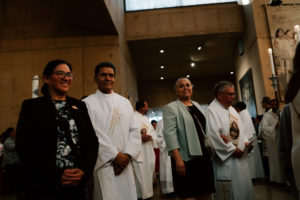 Deacons and their wives prepare to process into the Cathedral of Our Lady of the Angels during the Chrism Mass on March 30. (Peter Lobato)