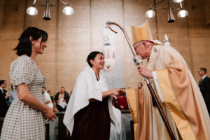 Archbishop José H. Gomez congratulates Jennifer Solares Gonzalez after she got baptized during the Easter Vigil on April 4 at the Cathedral of Our Lady of the Angels. (Peter Lobato)