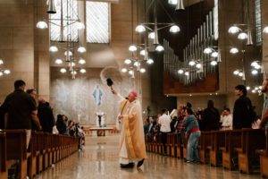 Archbishop José H. Gomez blesses the crowd with holy water during the Easter Vigil on April 4 at the Cathedral of Our Lady of the Angels. (Peter Lobato)