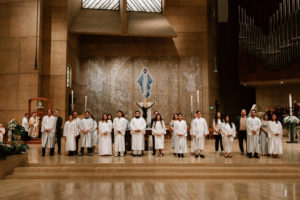 Those who were baptized into the Catholic Church stand on the altar during the Easter Vigil at the Cathedral of Our Lady of the Angels on April 4. (Peter Lobato)