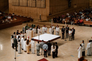 Those entering fully into the Catholic Church stand on the altar during the Easter Vigil at the Cathedral of Our Lady of the Angels on April 4. (Peter Lobato)
