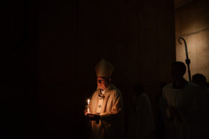 Archbishop José H. Gomez holds his flame lit by the Paschal candle during the Easter Vigil at the Cathedral of Our Lady of the Angels on April 4. (Peter Lobato)