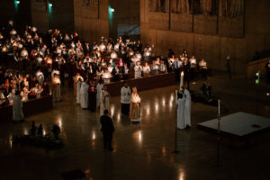 Attendees hold their flames lit by the Paschal candle during the Easter Vigil at the Cathedral of Our Lady of the Angels on April 4. (Peter Lobato)