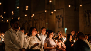 Attendees hold their flames lit by the Paschal candle during the Easter Vigil at the Cathedral of Our Lady of the Angels on April 4. (Peter Lobato)