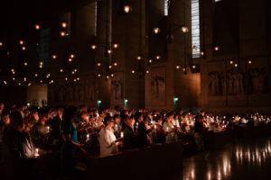 Attendees hold their flames lit by the Paschal candle during the Easter Vigil at the Cathedral of Our Lady of the Angels on April 4. (Peter Lobato)