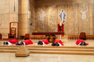 Archbishop José H. Gomez and other priests prostrate themselves on the altar during the Good Friday liturgy at the Cathedral of Our Lady of the Angels on April 3. (Reese Cuevas)