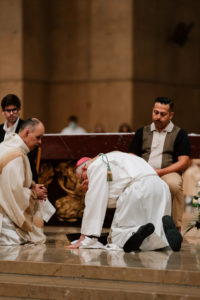 Archbishop José H. Gomez kisses the feet of a parishioner during the Washing of the Feet ritual during the Mass of the Lord's Supper at the Cathedral of Our Lady of the Angels on April 2. (Peter Lobato)