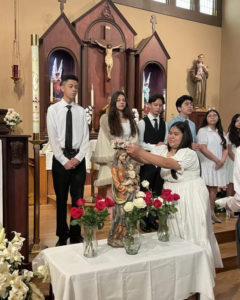 Young people at Holy Trinity Church in Atwater Village crown the Virgin Mary during a Mass. (Holy Trinity Church)