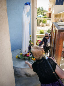 Parishioners at Sacred Heart Church in Lancaster lay flowers at the feet of the Virgin Mary in a May crowning event. (Katie Trejo)