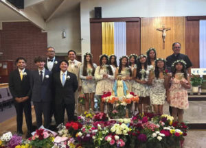 Students at St. Bernard School in Glassell Park pose around a crowned statue of the Virgin Mary during a May crowning ceremony. (St. Bernard School)