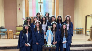 Students at St. Ignatius of Loyola School in Highland Park pose around a crowned statue of the Virgin Mary during a May crowning ceremony. (St. Ignatius of Loyola)