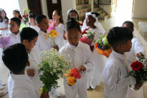Students at St. John Chrysostom School in Inglewood prepare to lay their flowers at the feet of their Virgin Mary statue during a May crowning event. (St. John Chrysostom School)