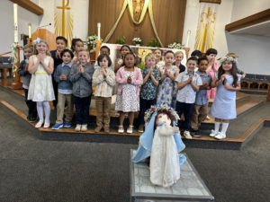 The kindergarten class at St. Raphael School in Santa Barbara poses around a doll of the Virgin Mary for their May crowning event. (St. Raphael School)