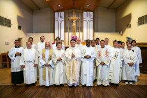 Father Shengda (Martin) Zhu poses with priests, deacons and altar servers following his first Mass at his home parish of St. Thomas Aquinas Church in Monterey Park on May 31. (John Rueda)
