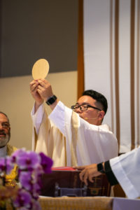 Father Shengda (Martin) Zhu holds the body of Christ during his first Mass at his home parish of St. Thomas Aquinas Church in Monterey Park on May 31. (John Rueda)
