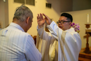 Father Shengda (Martin) Zhu offers a blessing following his first Mass at his home parish of St. Thomas Aquinas Church in Monterey Park on May 31. (John Rueda)