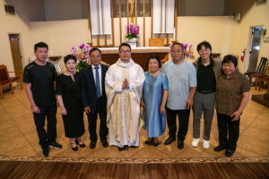 Father Shengda (Martin) Zhu poses with family and loved ones following his first Mass at his home parish of St. Thomas Aquinas Church in Monterey Park on May 31. (John Rueda)