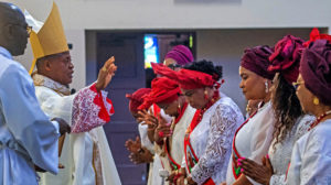 Cardinal Peter Ebere Okpaleke of Ekwulobia, Nigeria, blesses women at the offertory during a special May 31 Mass at St. Eugene Church in South LA. The cardinal visited LA as part of a tour visiting Nigerian Catholics living in the U.S. (Michael Goulding)