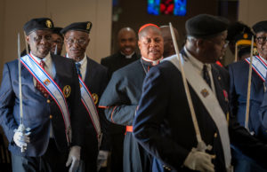 Cardinal Peter Ebere Okpaleke of Ekwulobia, Nigeria, is flanked by the Knights of Columbus during a special May 31 Mass at St. Eugene Church in South LA. The cardinal visited LA as part of a tour visiting Nigerian Catholics living in the U.S. (Michael Goulding)