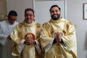 Father David Zamora poses with his father, Miguel, a deacon, during his first Mass at his home parish of Sacred Heart Church in Lancaster on May 31. (Katie Trejo)