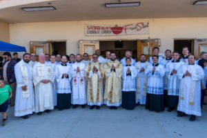 Father David Zamora poses with priests, deacons and altar servers following his first Mass at his home parish of Sacred Heart Church in Lancaster on May 31. (Katie Trejo)