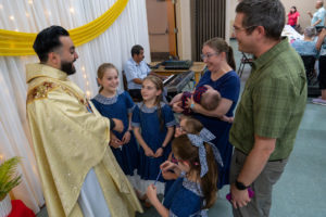 Father David Zamora speaks with well-wishers following his first Mass at his home parish of Sacred Heart Church in Lancaster on May 31. (Katie Trejo)
