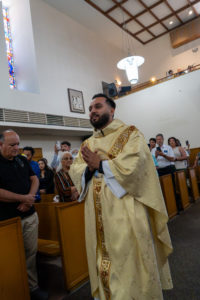 Father David Zamora processes in during his first Mass at his home parish of Sacred Heart Church in Lancaster on May 31. (Katie Trejo)