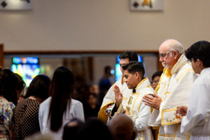 Father Jerick Alenton offers a blessing to those who brought up the Communion gifts during his first Mass at his home parish of St. Clare of Assisi Church in Santa Clarita on May 31. (Joe Garcia III)