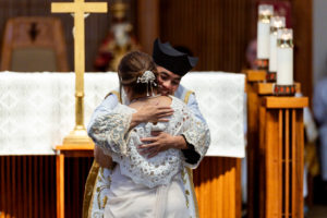 Father Jerick Alenton hugs his mother at the end of his first Mass at his home parish of St. Clare of Assisi Church in Santa Clarita on May 31. (Joe Garcia III)