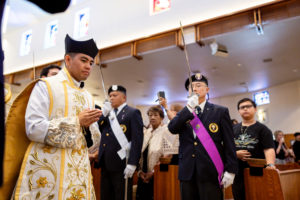 Father Jerick Alenton processes in wearing a biretta to begin his first Mass at his home parish of St. Clare of Assisi Church in Santa Clarita on May 31. (Joe Garcia III)